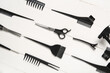 Set of hairdresser's tools on white wooden background
