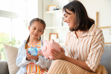 Sticker - Little girl and her mother with piggy banks at home