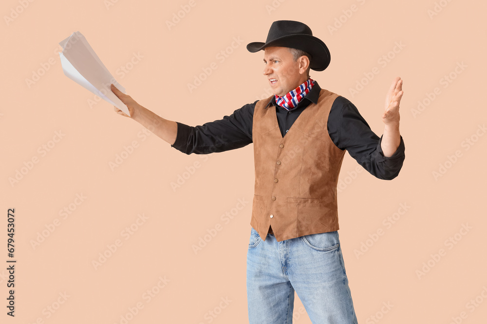 Mature actor dressed as cowboy reading film script on beige background