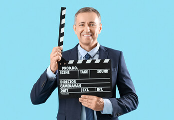 Poster - Mature actor with movie clapper on blue background