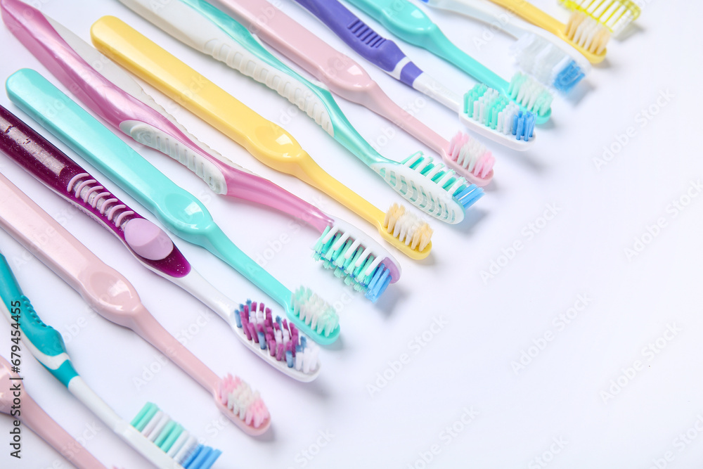 Colorful plastic toothbrushes on white background.