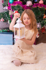 Wall Mural -  A beautiful elegant girl near the Christmas tree in the New Year. Holiday. New Year. The child is a model.