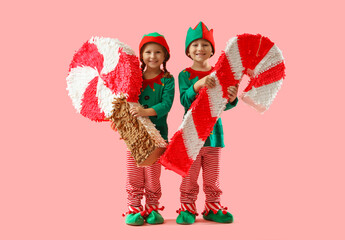 Sticker - Cute little elves with candy pinatas on pink background