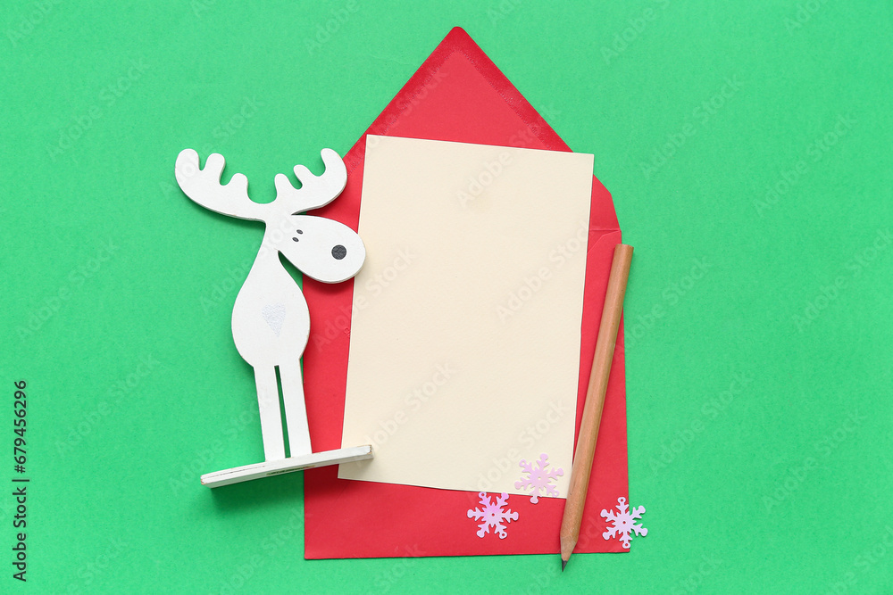 Beautiful composition with blank Christmas card on green background