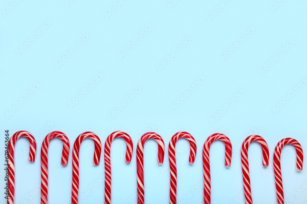 Christmas candy canes on blue background