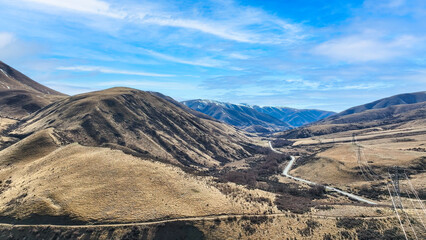 Wall Mural - Drone perspective photo of the extreme terrain of the Lindis Pass alpine mountain pass