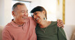 © Azeemud/peopleimages.com - Happy couple, together and embrace on sofa in living room with laugh for funny joke, conversation or talk. Senior man, woman and hug for love, care or support with marriage, bond and communication