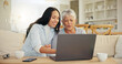 © Azeemud/peopleimages.com - Woman, senior mom and laptop with teaching, reading and typing for email notification, web or search. Computer, elderly mother and daughter with click, learning and family home lounge on social media