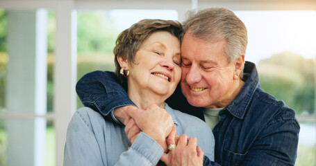 Wall Mural - Senior couple, hug and smile at home for love, loyalty and retirement bliss in marriage commitment. Mature man, woman or embrace for gratitude in together, peace wellness and kindness in family house