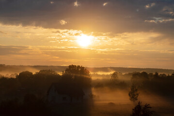 Wall Mural - sunset over village in belarus