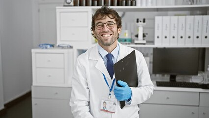 Sticker - Cheery blond bearded young man, a confident scientist, enjoying his successful research in the lab, radiating positivity with his toothy smile.