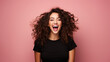 Happy wonderful young woman with long curly hair excited isolated on pink background
