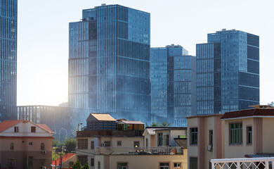 Canvas Print - Modern office buildings and old houses in the city