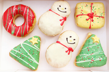 Wall Mural - Paper Box Filled with Delectable Assorted Christmas Decorated Doughnuts