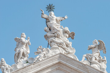 Wall Mural - Venice, Italy. Beautiful angels with wings and Saint Maria statues at the roof of Church Chiesa di Santa Maria Assunta, Baroque catholic church with sacred medieval art