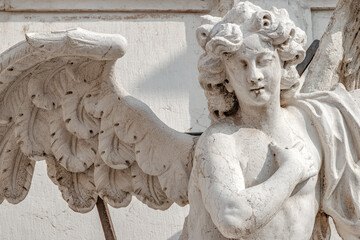 Wall Mural - Venice, Italy. Beautiful angel with wings and light. Church Chiesa di Santa Maria Assunta, Baroque catholic church with sacred medieval art