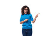 surprised slim young caucasian woman with curls dressed in a blue t-shirt and jeans