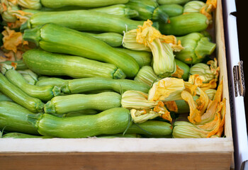 Wall Mural - Nice. French market. Fresh zucchini with flowers sold at the market. Zucchini flowers are used in traditional French cuisine