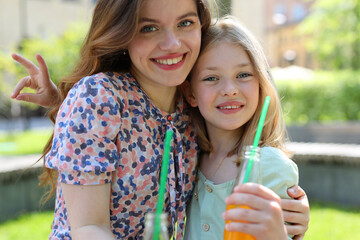 A happy family moment in the park — mother and daughter enjoying nature, love, and togetherness.