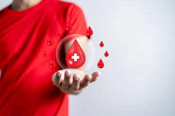 Wall Mural - Man hands holding virtual donation blood icon, blood transfusion, world blood donor day, world hemophilia day concept.