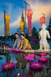 Pretty Asian Thai women holding a Krathong floating on water, Asian women in traditional Thai dress bring Krathong to float on Loy Krathong Festival Day, Popular traditions culture of Thailand.