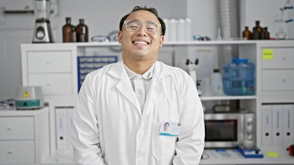 Sticker - Sparkling smile on a confident young chinese man, a specializing scientist, standing proud in his lab amidst the intricacies of science