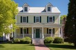 © altitudevisual - drama shot of two-story colonial house in harsh daytime light