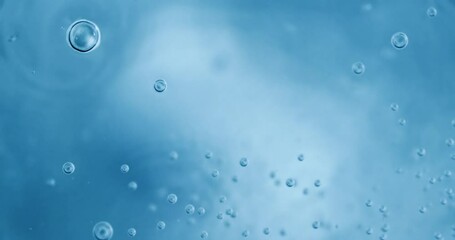 Wall Mural - Oxygen bubbles in water on a blue abstract background on super slow motion.