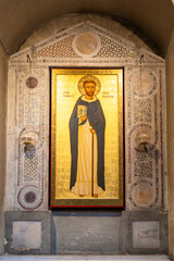 Sticker - Medieval catholic saint portraited on a  golden background decorating ancient stone wall inside old church in Italy