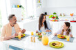 © deagreez - Photo of peaceful friendly cheerful family sit eat homemade food laugh good mood kitchen table apartment inside