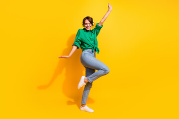 Poster - Full length photo of positive carefree girl dressed green shirt headphones dancing isolated yellow color background