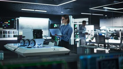 Fototapete - Portrait of a Female Technical Specialist Working in High Tech Research Laboratory with Modern Equipment: Female Developer Using Laptop to Write Code for an Advanced-Technology Delivery Robot
