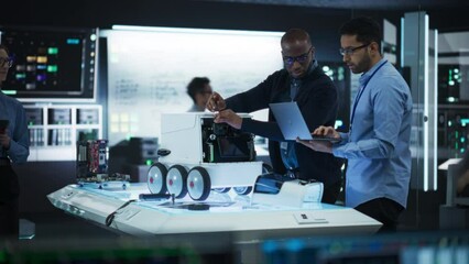 Fototapete - Diverse Team of Industrial Robotics Specialists Gathered Around a Table With a Mobile Robot. Engineers Discussing an Automated Robotic Delivery Assistant with Artificial Intelligence
