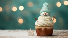  A Frosted Cupcake With A Frosted Snowman On Top And A Snowflake In The Background.