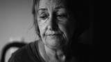 Fototapeta  - Senior woman struggling with depression, close-up face of dramatic elderly lady in quiet despair, preoccupied anxious emotion