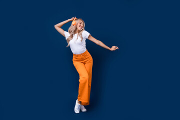 Sticker - Full length photo of adorable cheerful girl dressed stylish clothes having fun empty space isolated on dark blue color background