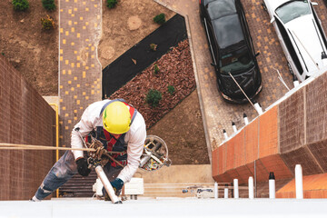 High-altitude worker. Industrial climber.High-rise works. Rock-climber. Industrial mountaineering. worker on high rise building