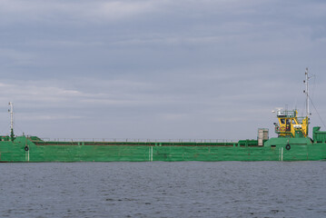 Poster - 
GREEN SCOW ON THE WATERWAY - Barge sails through the port canal to sea
