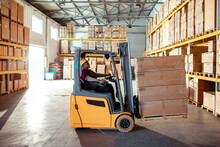 Male Forklift Operator at Work in Warehouse