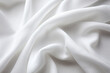 White colour satin cloth folds on closeup shot abstract background. Silk fabric tissue curves