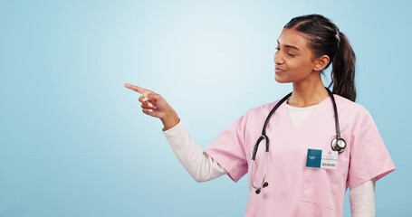 Canvas Print - Face, smile and woman doctor with hand pointing in studio for healthcare, advice or promo on blue background. Hospital, presentation and portrait of lady nurse with schedule, checklist or timeline