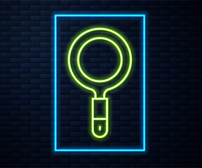 Sticker - Glowing neon line Magnifying glass icon isolated on brick wall background. Search, focus, zoom, business symbol. Vector