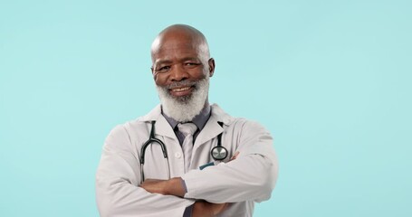 Canvas Print - Senior, black man and professional doctor with arms crossed in confidence against a blue studio background. Portrait of confident mature African male person or medical surgeon for healthcare advice