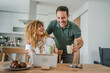 © Miljan Živković - happy couple man and woman husband and wife morning routine use tablet
