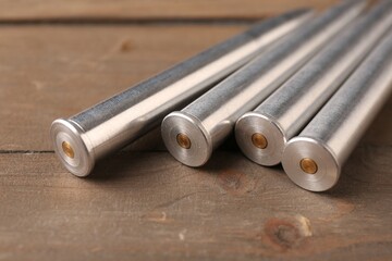 Poster - Many metal bullets on wooden table, closeup