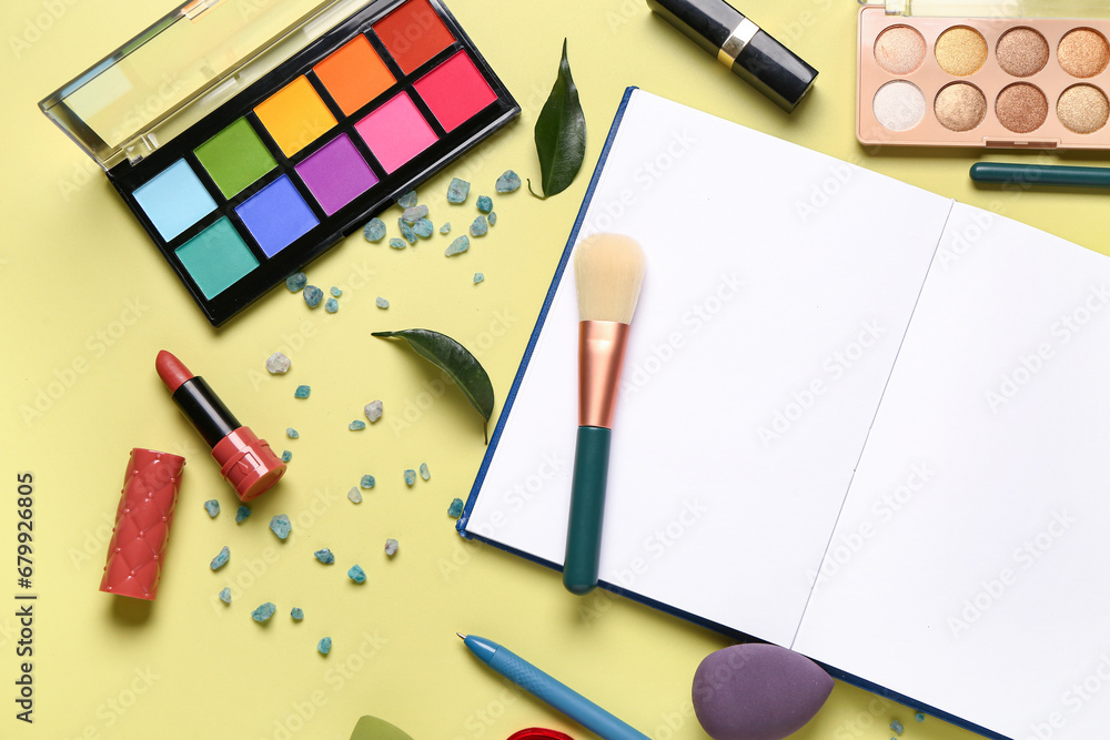 Composition with makeup cosmetics, sea salt and notebook on yellow background