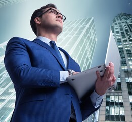 Wall Mural - Businessman against buildings in business concept