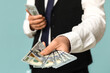 © Pixel-Shot - Young businessman with bribe on blue background, closeup