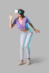 Wall Mural - Young woman using VR glasses on light background