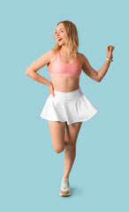 Poster - Beautiful young sporty woman on blue background. Weight loss concept